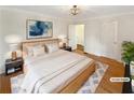 Comfortable primary bedroom with hardwood flooring, a cozy rug, and neutral decor at 156 Page Pl, Canton, GA 30114
