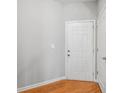 Bright entryway featuring white door, wood floor, neutral paint, and white trim at 2297 Elmbridge Rd, Buford, GA 30519