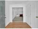 View of the foyer leading into the living room with hardwood floors and white walls at 223 Ivy Creek Dr, Loganville, GA 30052