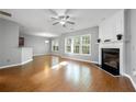Open living room with hardwood floors, fireplace, and large windows for natural light at 3258 Welmingham Sw Dr, Atlanta, GA 30331