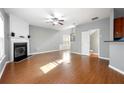 Spacious living room with fireplace, hardwood floors, and open access to stairway and back hall at 3258 Welmingham Sw Dr, Atlanta, GA 30331