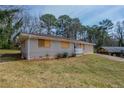 A single-story home with a well-maintained lawn and mature trees at 4094 E Glade Ct, Decatur, GA 30035