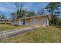 A single-story home with a well-maintained lawn and a long private driveway at 4094 E Glade Ct, Decatur, GA 30035