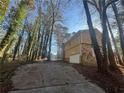 Exterior view of driveway approaching the house, showing the garage and stone facade at 4820 Banner Elk Dr, Stone Mountain, GA 30083