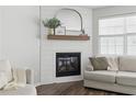 Close up of the electric fireplace surrounded by a shiplap wall with decoratively styled mirror and mantel at 129 Swanee Ln, Woodstock, GA 30188