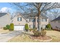 Two-story brick home with black shutters, a well-manicured lawn, and mature landscaping at 165 Babbling Brook, Mcdonough, GA 30252