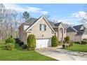 Beautiful two-story brick home with an attached garage, green lawn, and manicured greenery at 165 Babbling Brook, Mcdonough, GA 30252