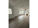 Bright living room featuring wood-look floors, fireplace and large windows at 211 Wellington Sw St, Atlanta, GA 30314