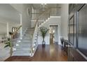 Inviting foyer featuring hardwood floors, a staircase with white railings, and a view into other living spaces, creating a warm welcome at 4330 Landover Nw Way, Suwanee, GA 30024