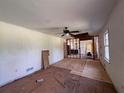 Spacious living room ready for renovation, featuring exposed flooring and ceiling fan at 4625 Orkney Sw Ln, Atlanta, GA 30331