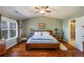 Spacious main bedroom with hardwood floors, large window, vaulted ceiling, and ensuite bathroom at 2474 Whiteoak Se Run # 18, Smyrna, GA 30080