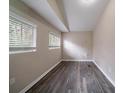Cozy bedroom with wood-look floors, two windows, and neutral wall color at 3680 Brookcrest Cir, Decatur, GA 30032