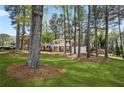 Traditional two-story home with a manicured lawn, mature trees, and charming curb appeal at 3973 Elmscourt Dr, Stone Mountain, GA 30083