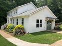 Side view of the home highlighting the manicured lawn and landscaping at 4424 Lower Fayetteville Rd, Sharpsburg, GA 30277
