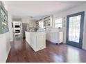 Bright kitchen with white cabinets, a center island, and stainless steel appliances at 4424 Lower Fayetteville Rd, Sharpsburg, GA 30277