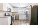 A well-lit kitchen featuring stainless steel appliances, granite countertops, and white cabinets at 4641 Waterford Ct, Atlanta, GA 30338