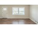 Inviting living room features wood-look flooring and fresh paint with ample natural light at 1624 Linda Dr, Decatur, GA 30032