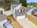Two-story home features brick accents, a two-car garage, and a well-maintained lawn in a suburban neighborhood at 2365 Parkside Club Ln, Lawrenceville, GA 30044