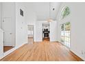 Bright living room with hardwood floors, high ceilings, and sliding doors to a backyard at 2365 Parkside Club Ln, Lawrenceville, GA 30044