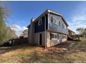 Rear exterior view shows combination of brick and siding with a door to a basement or lower level at 3633 Mill Glen Dr, Douglasville, GA 30135