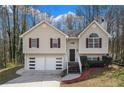 Inviting two-story home with a well-maintained lawn and attached two-car garage at 445 Settlers Ridge Ln, Hiram, GA 30141
