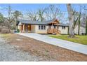 Attractive single-story home featuring fresh landscaping, a driveway, and wood porch at 2000 Fairburn Sw Rd, Atlanta, GA 30331