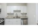 Bright kitchen featuring stainless steel appliances, granite counters, and white cabinets at 3164 Robin Rd, Decatur, GA 30032
