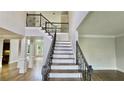 Elegant entryway with soaring ceilings, hardwood floors, iron-railed staircase and classic architectural details at 838 Natchez Valley Trce, Grayson, GA 30017