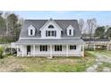 Charming home with a welcoming front porch, white columns, and a well-manicured lawn at 3121 Cox Cemetery Rd, Social Circle, GA 30025