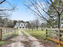 Exterior view of the white home with dormer windows and a long driveway at 3121 Cox Cemetery Rd, Social Circle, GA 30025