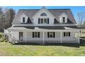 Beautiful two-story home featuring a covered front porch and a manicured lawn, perfect for relaxing and entertaining at 3121 Cox Cemetery Rd, Social Circle, GA 30025