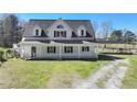 Charming two-story home with a covered front porch, a long driveway, and ample green space for outdoor activities at 3121 Cox Cemetery Rd, Social Circle, GA 30025