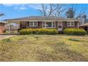 Inviting brick home with a neatly landscaped front lawn and carport, ideal for a relaxed suburban lifestyle at 965 Laurel St, Morrow, GA 30260