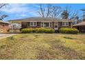 Charming single-story brick home with well-kept lawn and carport providing a blend of comfort and practicality at 965 Laurel St, Morrow, GA 30260