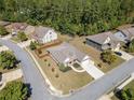 Aerial view of a well-maintained single-story home with manicured lawn, trees, and a long driveway in a suburban neighborhood at 2190 Leatherstone Dr, Powder Springs, GA 30127