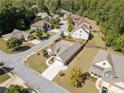 Aerial view showcases the property's landscaping, roof, and location in a suburban neighborhood with tree-lined streets at 2190 Leatherstone Dr, Powder Springs, GA 30127