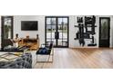 Beautiful living room with modern furniture, art, and large black framed windows at 2824 Tupelo Se St, Atlanta, GA 30317
