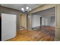 Open living room with hardwood floors and vintage light fixtures, ready for a modern refresh at 1347 Westmont Sw Rd, Atlanta, GA 30311