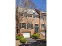 Traditional brick townhouse featuring an attached garage and meticulously maintained yard at 238 15Th Ne St # 18, Atlanta, GA 30309