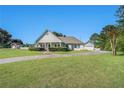 Spacious home features a well-manicured lawn, circular drive, and mature trees at 950 Sundew Se Dr, Conyers, GA 30013
