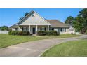 Charming one-story home boasts mature landscaping and a welcoming front porch at 950 Sundew Se Dr, Conyers, GA 30013