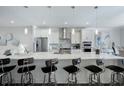Gourmet kitchen with stainless steel appliances, quartz countertops, and breakfast bar at 1049 Brandsford Nw St # 27-01, Atlanta, GA 30318