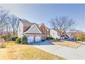 Charming two-story brick home with a two-car garage and well-manicured lawn at 1510 Ridgemill Ter, Dacula, GA 30019