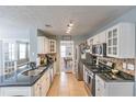 Well-equipped kitchen featuring granite countertops, stainless steel appliances, and tile backsplash at 1510 Ridgemill Ter, Dacula, GA 30019