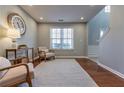Cozy sitting room featuring hardwood floors, a large window, and comfortable seating for relaxation at 1510 Ridgemill Ter, Dacula, GA 30019