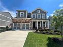 Charming two-story home with stone accents, a two-car garage, and a well-manicured lawn at 316 Willow Cv, Canton, GA 30114