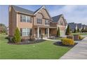 Charming two-story home boasting a manicured lawn and beautiful landscaping, enhancing its curb appeal at 681 Deer Springs Way, Loganville, GA 30052