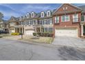 Desirable townhome with attached two car garage, lush lawn and manicured landscaping at 7467 Portbury Park Ln, Suwanee, GA 30024