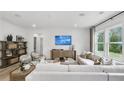 Inviting living room with large windows, comfortable seating, and stylish decor for a relaxing atmosphere at 221 Kindness Cir, Mcdonough, GA 30252