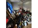 A cluttered room filled with tools, equipment, and covered furniture under a blue tarp at 2836 Oldknow Dr, Atlanta, GA 30318